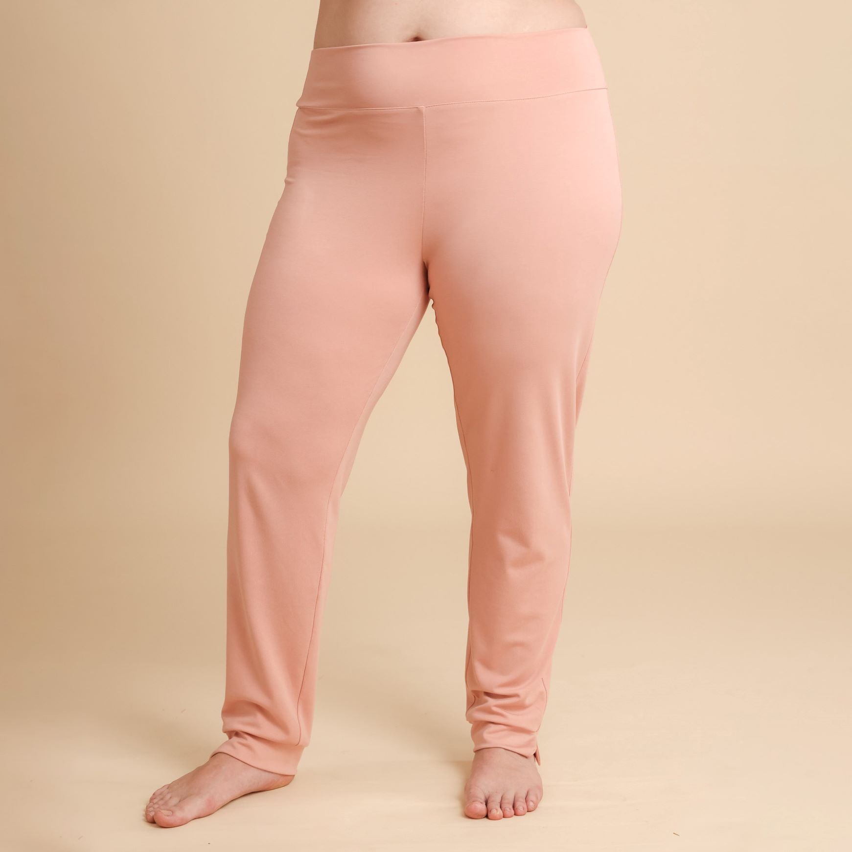 Pink leggings worn by a person on a beige background
