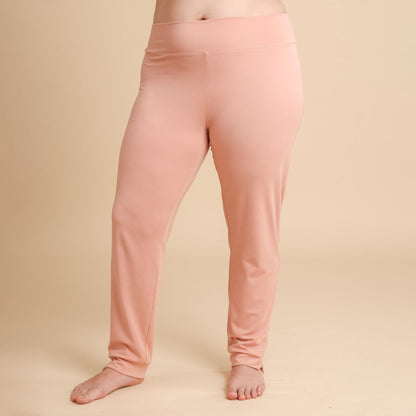 Pink leggings worn by a person on a beige background