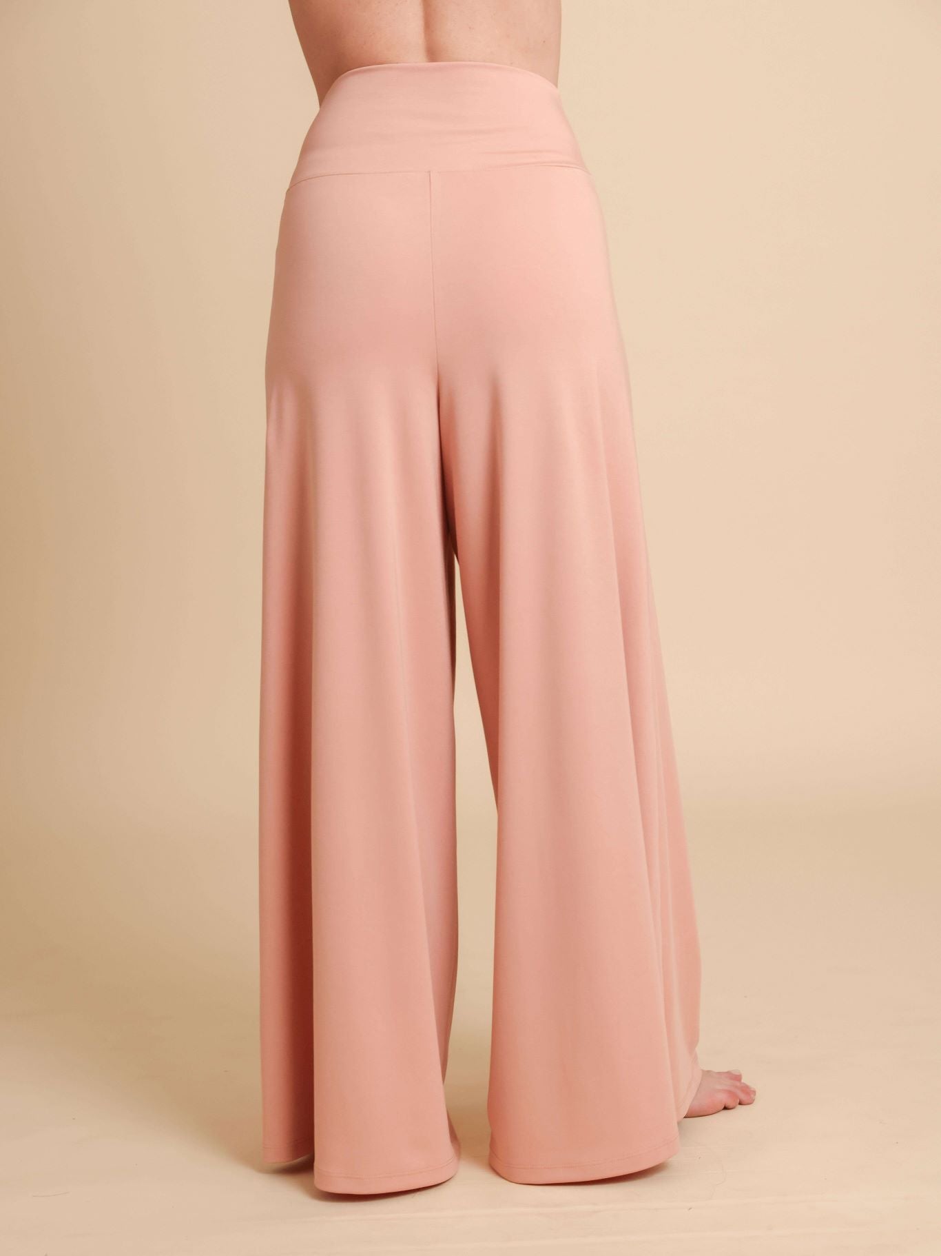Pink wide-leg pants on a beige background