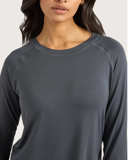 Person wearing a dark gray long-sleeve shirt against a white background