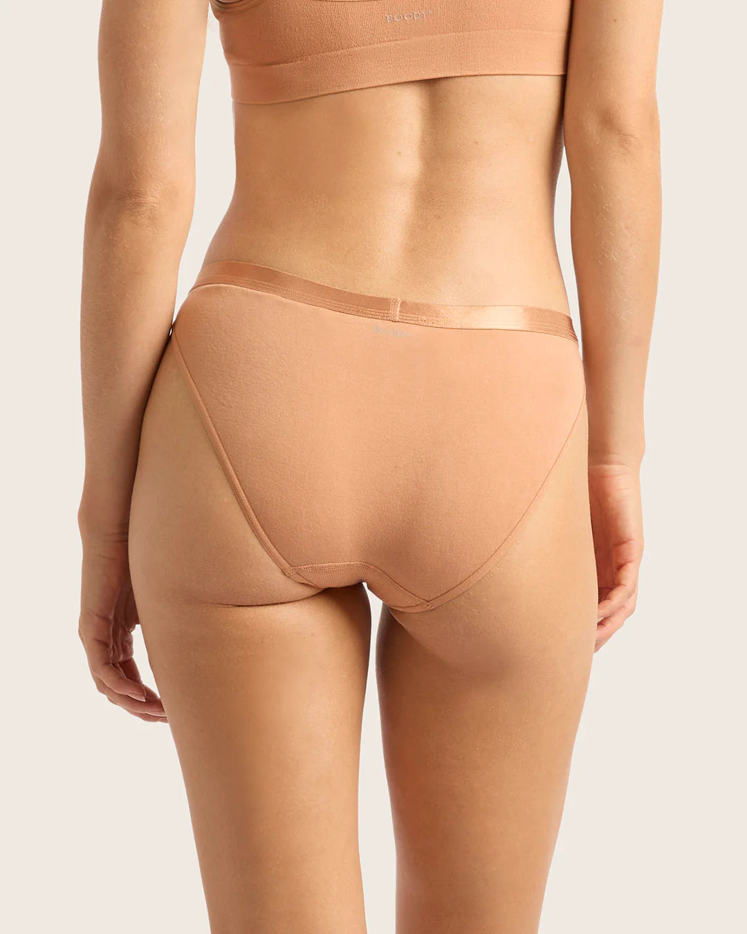 Beige shapewear on a plain background