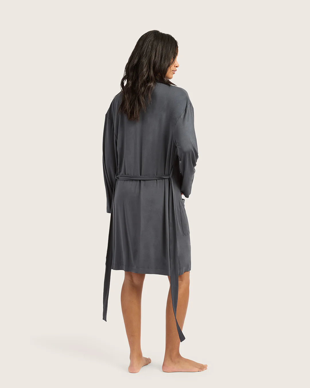 Woman wearing a gray robe on a white background
