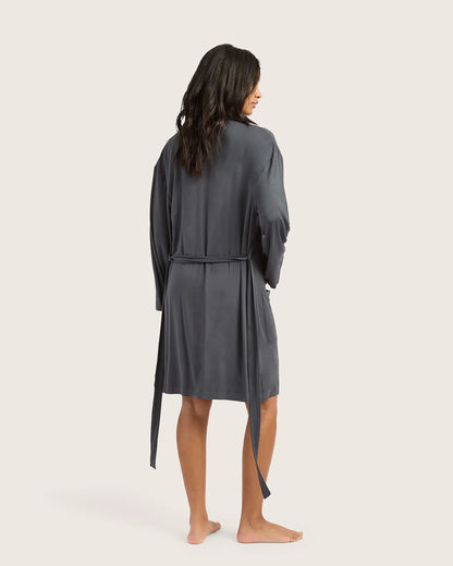 Woman wearing a gray robe on a white background
