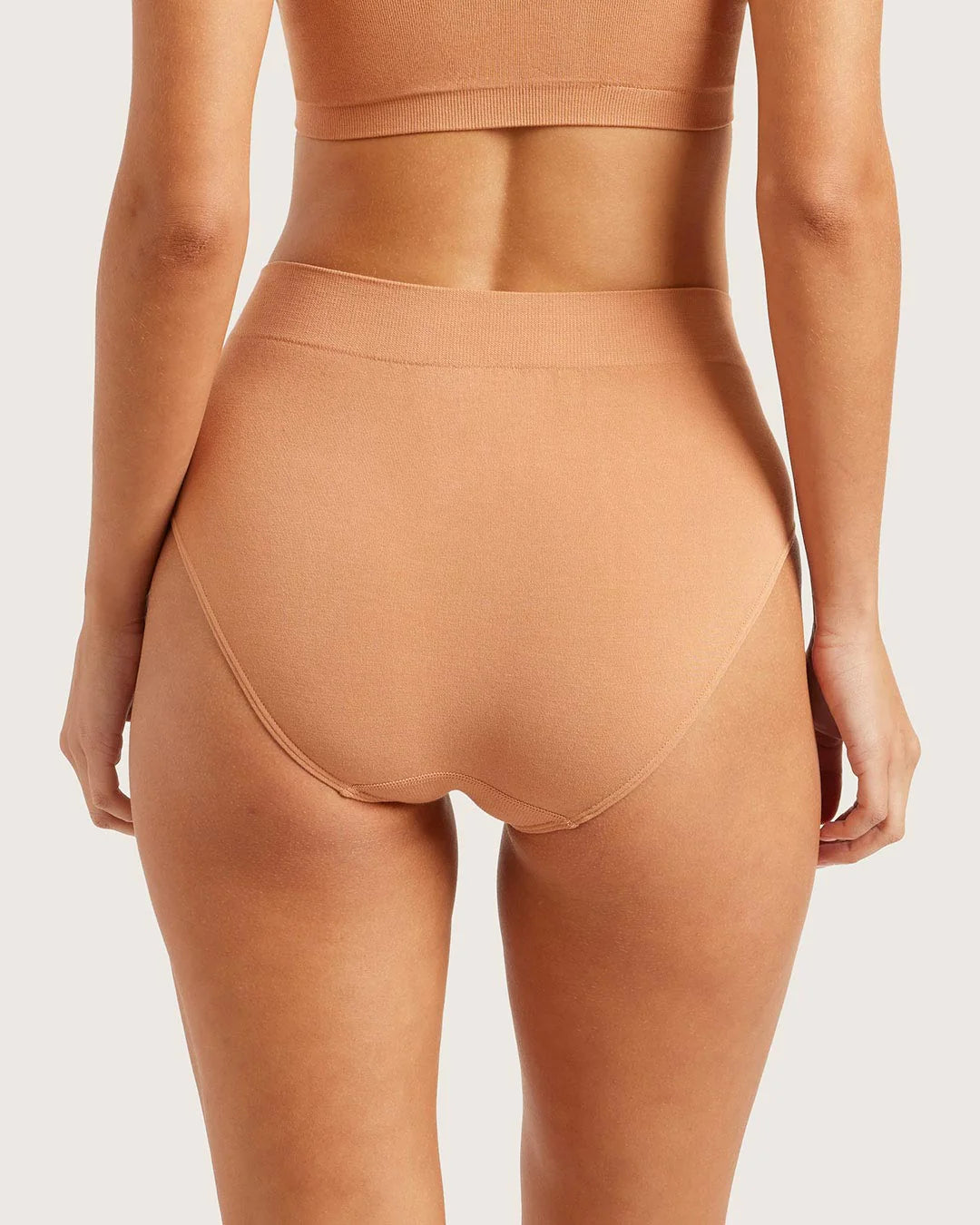 Brown high-waisted underwear on a plain background