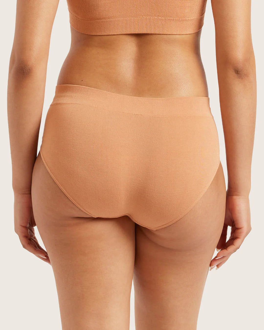Tan high-waisted underwear on a plain background