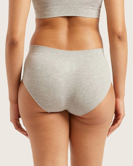 Person wearing gray underwear on a plain background