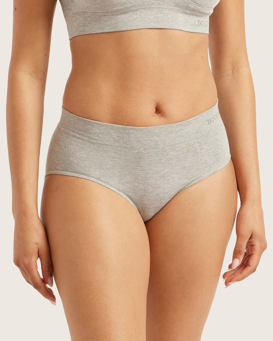 Person wearing gray underwear on a plain background